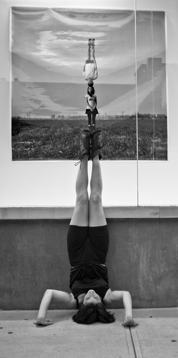 Performer Annika Franklin does a headstand on 27th Street in NYC.